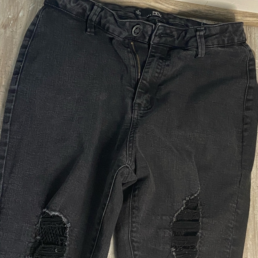 Black skinny jeans with rips and fishnet layering size 9
